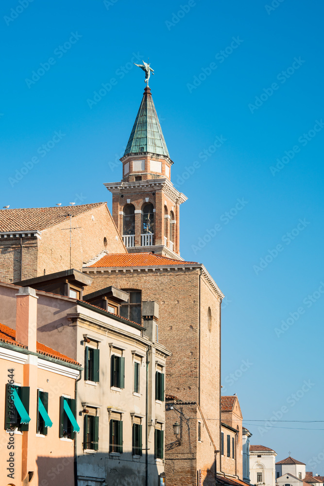 tower of San Giacomo church and houses in Chioggioa, Italy 