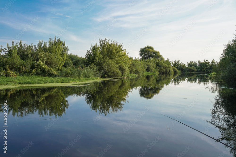 Beautiful summer landscape with pretty river and colorful trees. View of the sky with beautiful clouds. Stock photo Beautiful summer landscape with pretty river and colorful trees. View of the sky with beautiful clouds. Stock photo