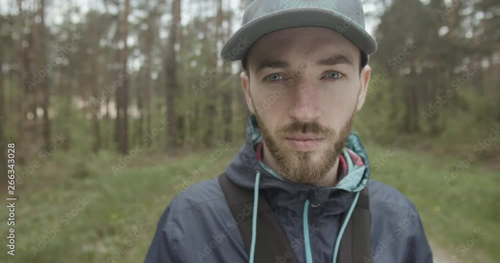 Portrait of young bearded man in cap in the forest Portrait of young bearded man in cap in the forest