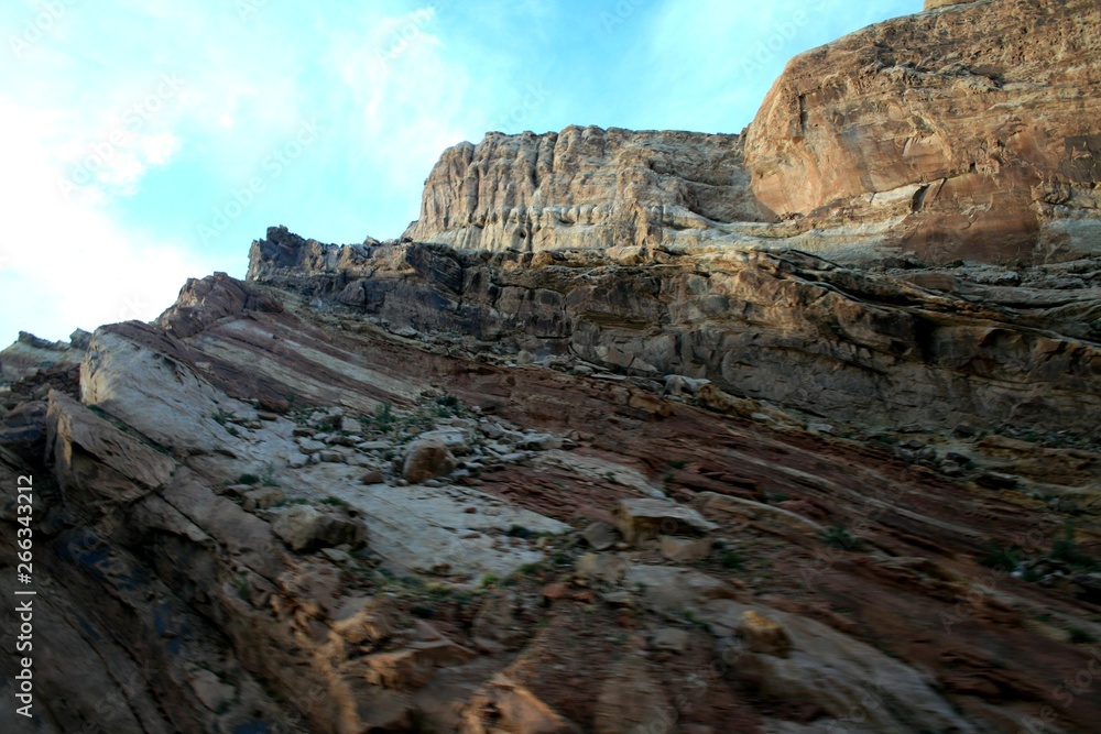 Obraz premium Dragon Canyon in Utah. Clear sunny weather, beautiful landscape. Eroded landscape in the Black Dragon Canyon, Utah. The sky is clear, the clouds. Red kayon minerals. In the foreground desert plants
