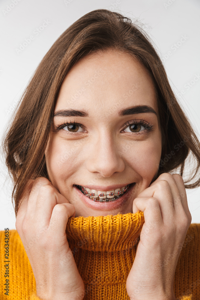 Close up of a smiling pretty girl wearing sweater Close up of a smiling pretty girl wearing sweater