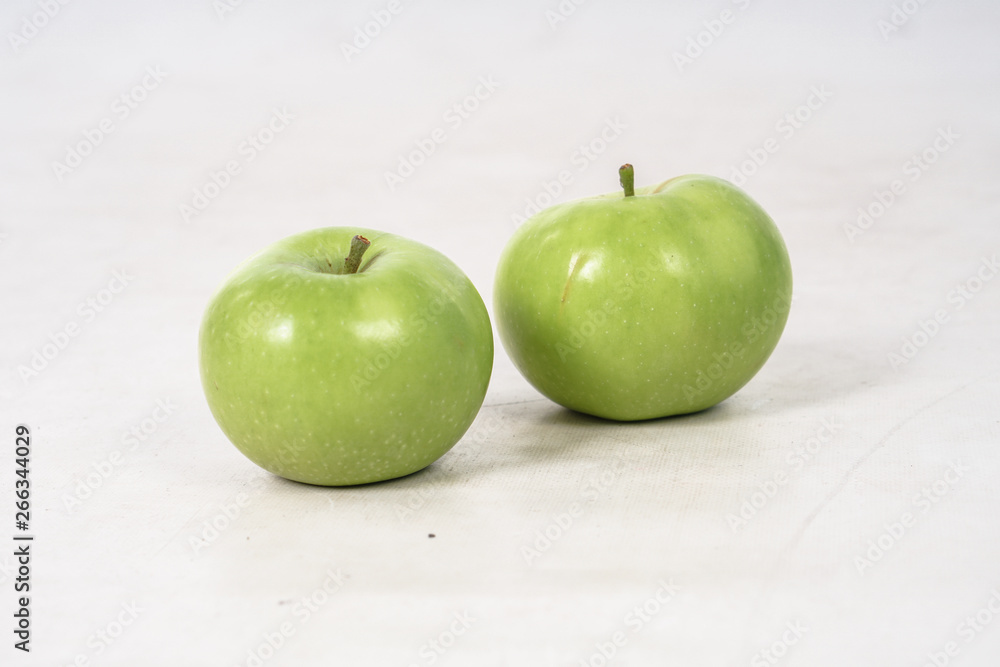 Two lovely green juicy apples on a white isolated background. Vegetarian food. Stock photo Two lovely green juicy apples on a white isolated background. Vegetarian food. Stock photo
