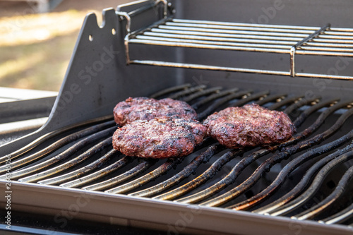 hamberger meat over the bbq grill photo