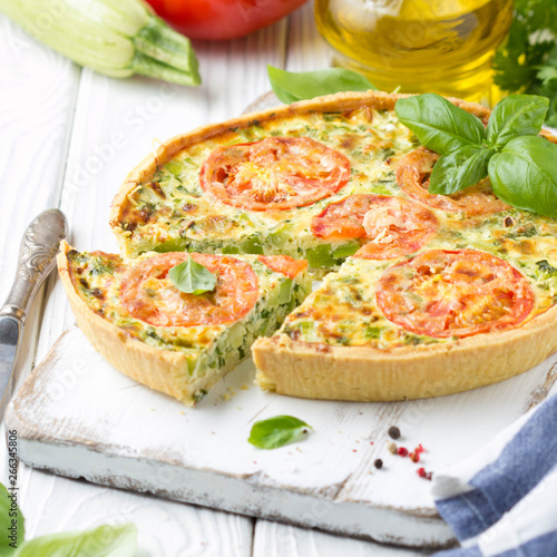 Quiche with vegetables (squash, tomatoes, cheese, herbs, green onions), open tart, French cuisine, traditional pastries