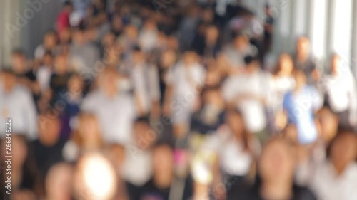 During the morning rush hour Lots of people are walking On the street