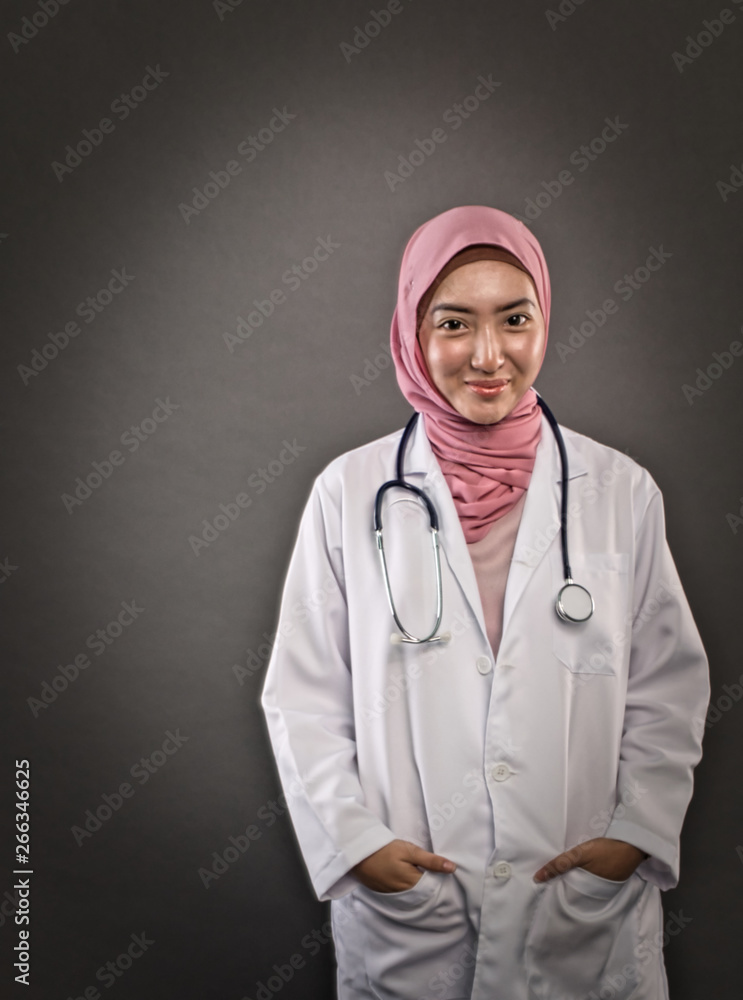 studio shot, closeup portrait of friendly and confident young hijab female doctor over dark background studio shot, closeup portrait of friendly and confident young hijab female doctor over dark background