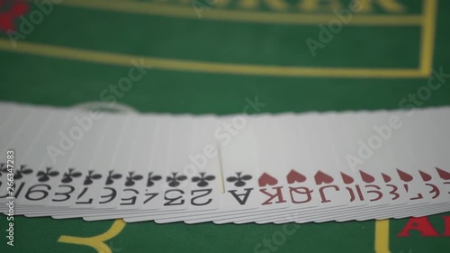 Dealer spreading the deck at poker game in casino