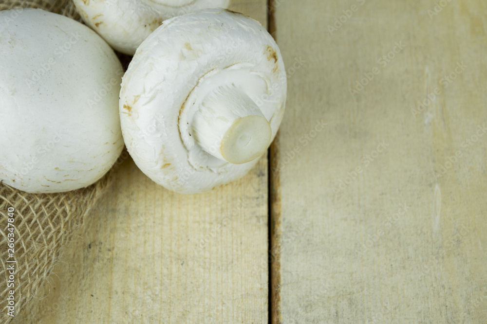 Champignon mushrooms on wooden background Champignon mushrooms on wooden background