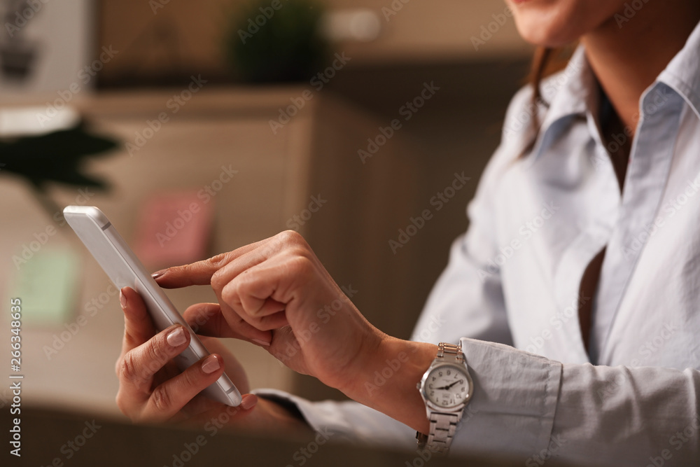 Obraz premium Close up of businesswoman using mobile phone in the office.