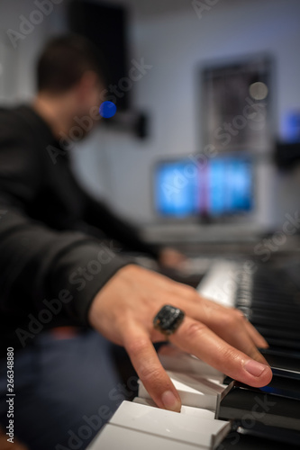 man playing a piano in a studio recording keys hand human form stage string keyboard synt creation art sound lesson teach course class info know chord melody rhythm photo