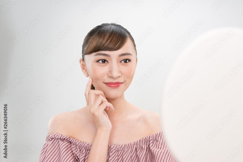 Beautiful smiling girl with natural makeup touching face. Beautiful smiling girl with natural makeup touching face.