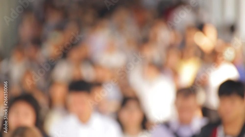 During the morning rush hour Lots of people are walking On the street