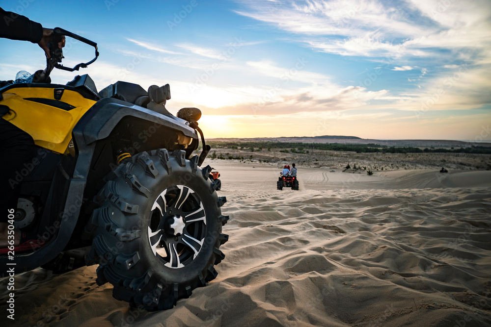 Summer offroad adventure on atv in sand quarry. Entertainment of tourists in desert in MUI ne in