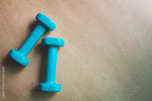 Fitness equipment dumbbells on color background. Flat lay.