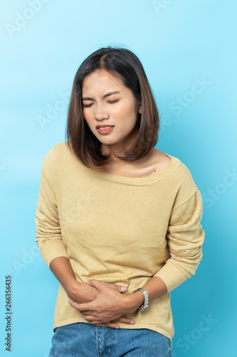 asian young woman having painful stomachache