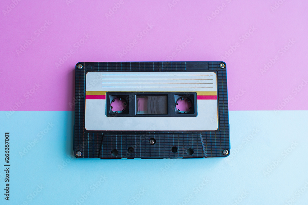 Fototapeta premium retro of tape cassette on blue and pink background. soft focus.