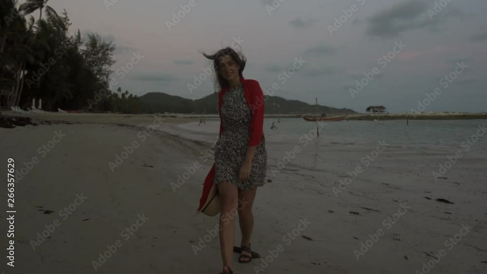 Beautiful girl walking on the beach in sunset golden hour. Portrait of ...