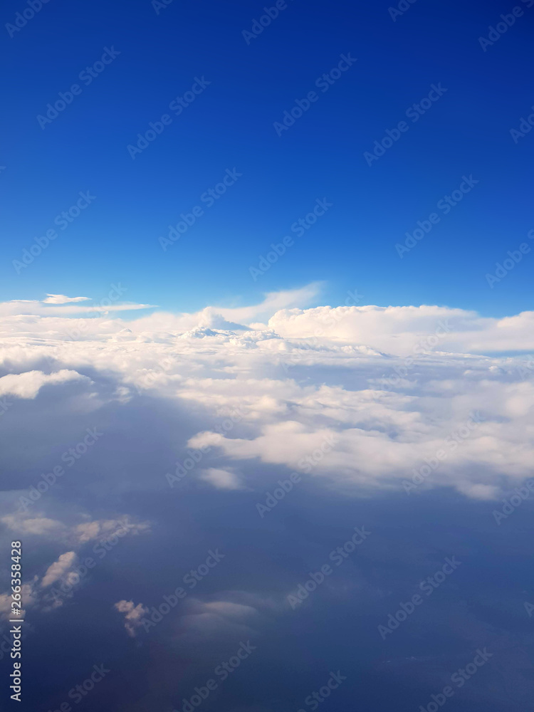 Blue Sky From the Plane with Mountain Looking Clouds Blue Sky From the Plane with Mountain Looking Clouds