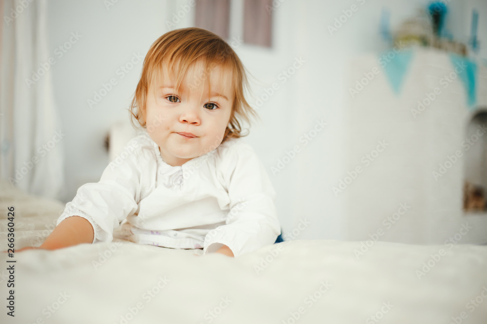 Cute little girl sitting in a room. Child have fun at home Cute little girl sitting in a room. Child have fun at home