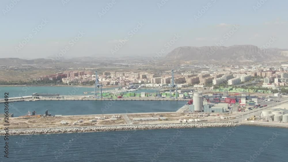 A beautiful wide slow-moving aerial shot of the Alicante harbor in Spain surrounded by the magnificent landscape and mountains on a beautiful summer day. Film LUT and grade added. A beautiful wide slow-moving aerial shot of the Alicante harbor in Spain surrounded by the magnificent landscape and mountains on a beautiful summer day. Film LUT and grade added.
