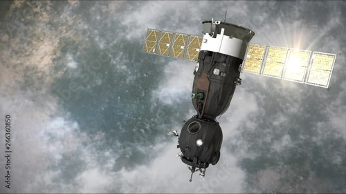 A Space ship is moving in the orbit and the solar panel is reflecting the sun. It is passing from the right to the left. Background: 'Thick Clouds'