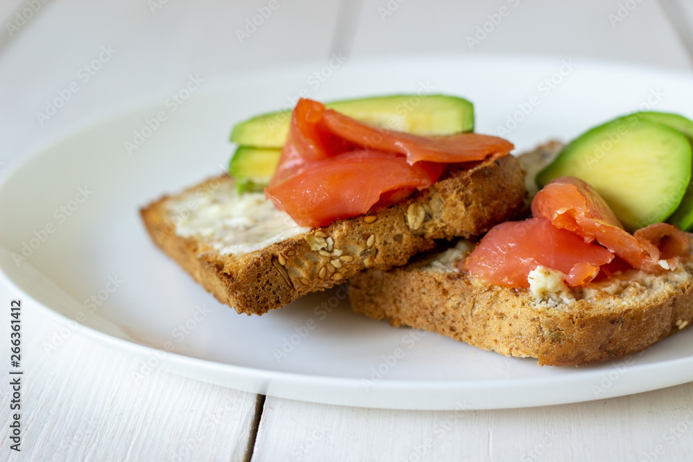 Sandwiches with trout and avocado on a white background. Healthy eating.