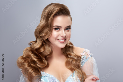 woman with perfect healthy and long hair looking to the camera and smiling