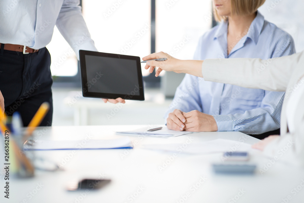 business, people and technology concept - close up of businessman showing tablet computer to colleagues at office business, people and technology concept - close up of businessman showing tablet computer to colleagues at office