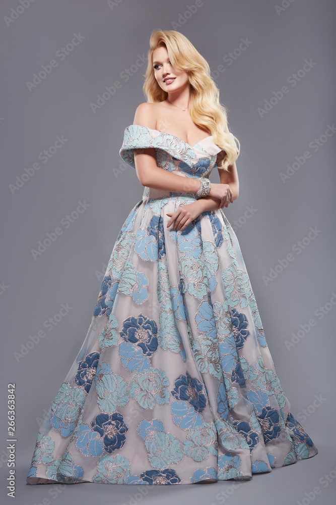 pretty girl in long dress with open shoulders and wavy hair