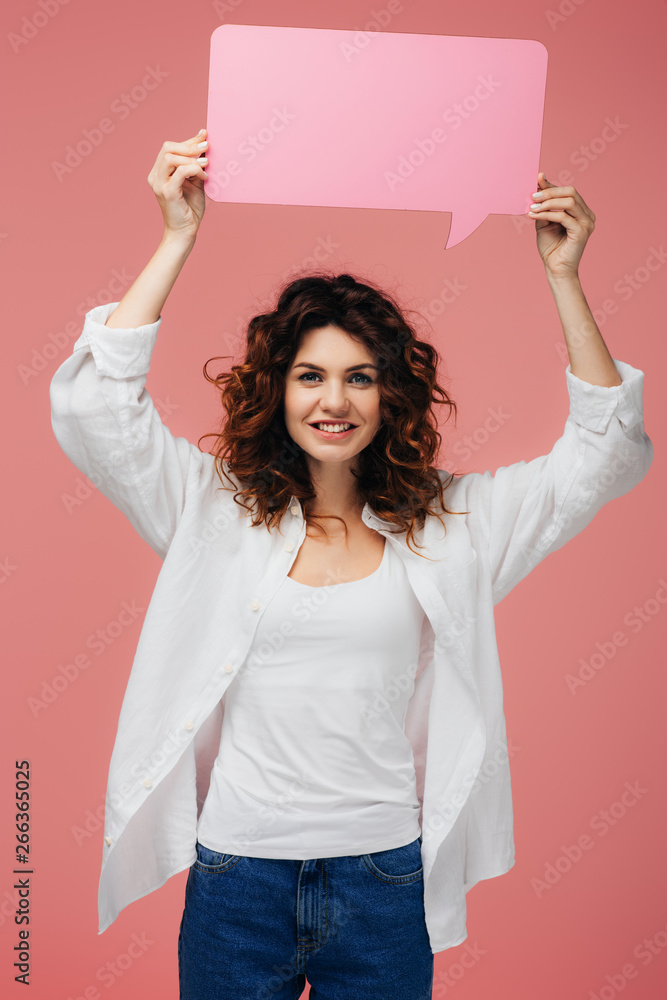 cheerful curly girl with red hair holding blank speech bubble on pink cheerful curly girl with red hair holding blank speech bubble on pink