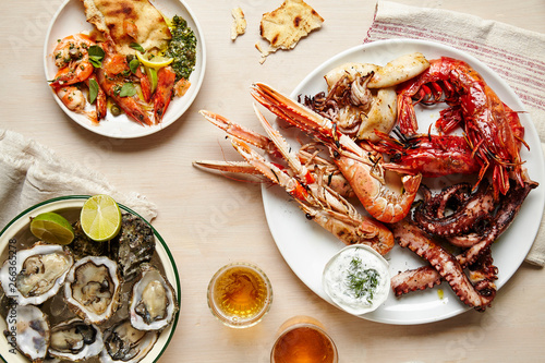 Tablescape featuring platters of fresh seafood and flatbread photo