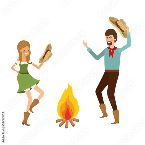 farmers couple dancing with straw hat and bonfire