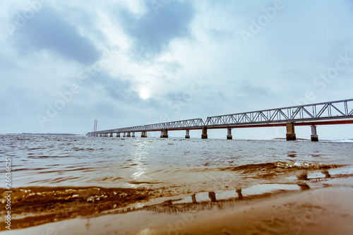 railway bridge over the river on a cloudy day © Лев Кирьянов
