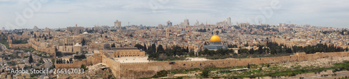 Beautiful panoramic aerial view of the Old City, Tomb of the Prophets and Dome of the Rock during a sunny and cloudy day. Taken in Jerusalem, Capital of Israel.