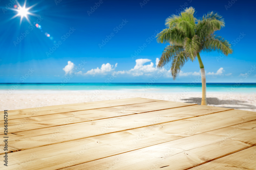 Desk of free space and summer background of ocean and beach with palm. Sunny day and blue sky. 