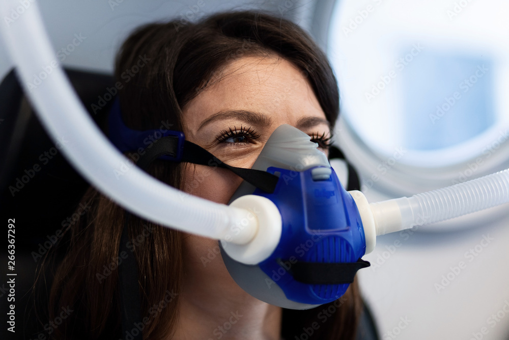 Woman breathing through oxygen mask in hyperbaric chamber. Stock Photo |  Adobe Stock