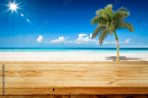 Fototapeta Naklejka Na Ścianę i Meble -  Desk of free space and summer background of ocean and beach with palm. Sunny day and blue sky. 