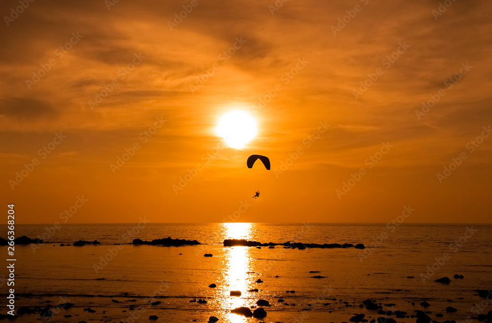 Extreme air sport on sunset on sea Extreme air sport on sunset on sea