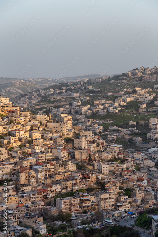 Aerial cityscape view of residential neighborhood during a sunny sunset. Taken in Jerusalem, Israel.