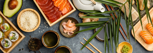Overhead shot of ingredients for sushi on dark blue background