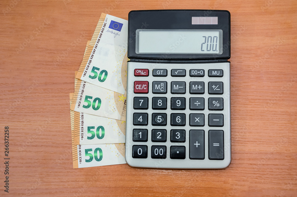 50 euros with a calculator on the table. View from above. 50 euros with a calculator on the table. View from above.