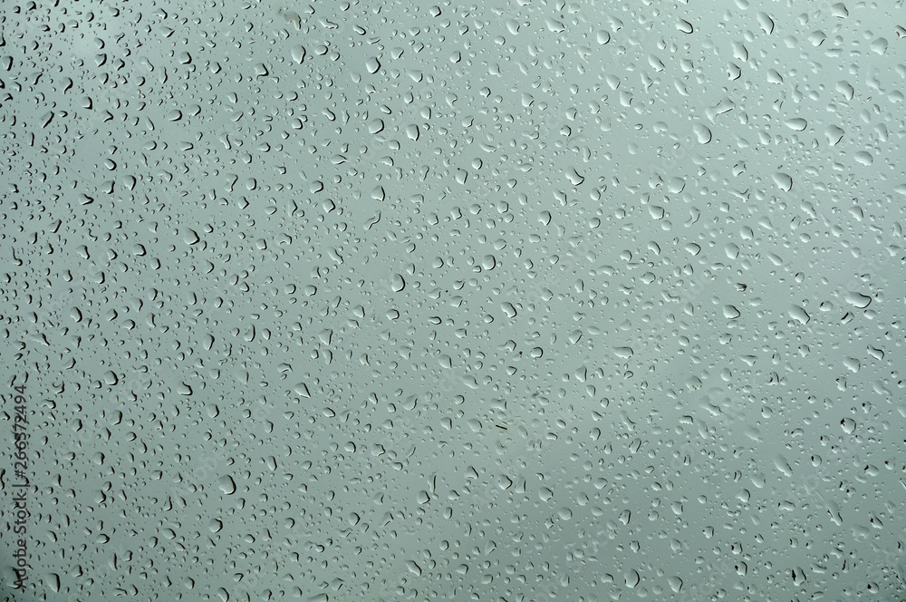 water drops on a glass sheet on gray rainy day water drops on a glass sheet on gray rainy day