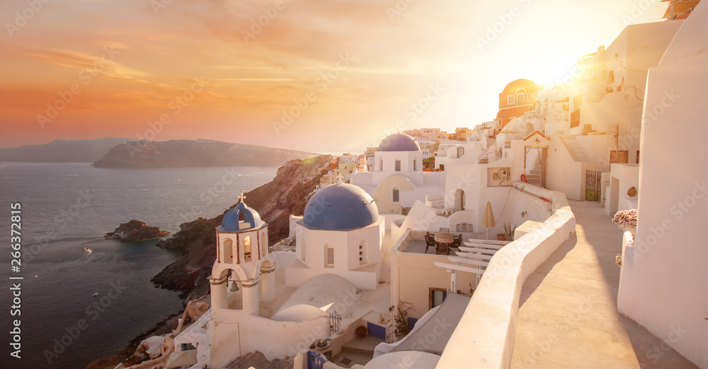 The famous three blue domes in Santorini at sunset - obrazy, fototapety, plakaty 