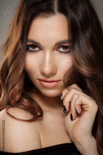 Beautiful woman with long brown curly hair.