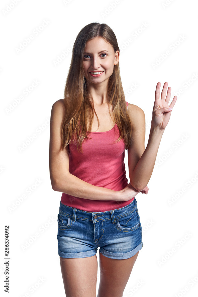 Happy woman in shorts showing four fingers Happy woman in shorts showing four fingers