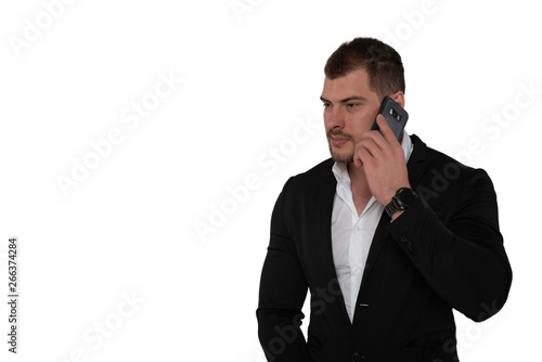 Beautiful serious business man in suit with smartphone on white background