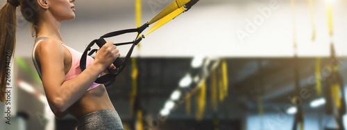 Trx training. Woman working out with fitness straps