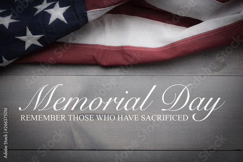 The flag of the United Sates on a grey plank background with memorial day