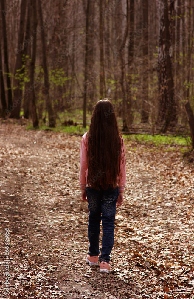 girl with long hair for a walk in the spring forest girl with long hair for a walk in the spring forest