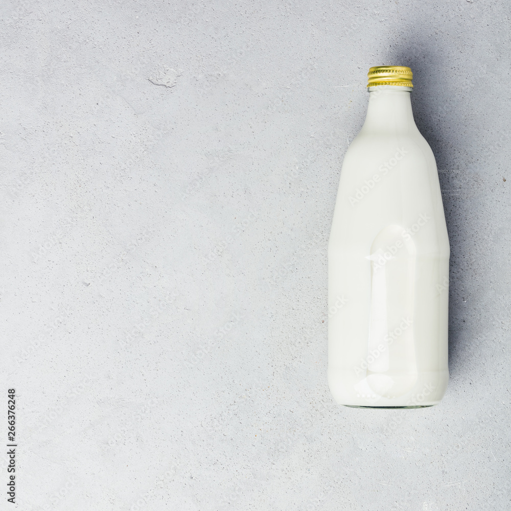 bottle of milk on grey concrete background bottle of milk on grey concrete background